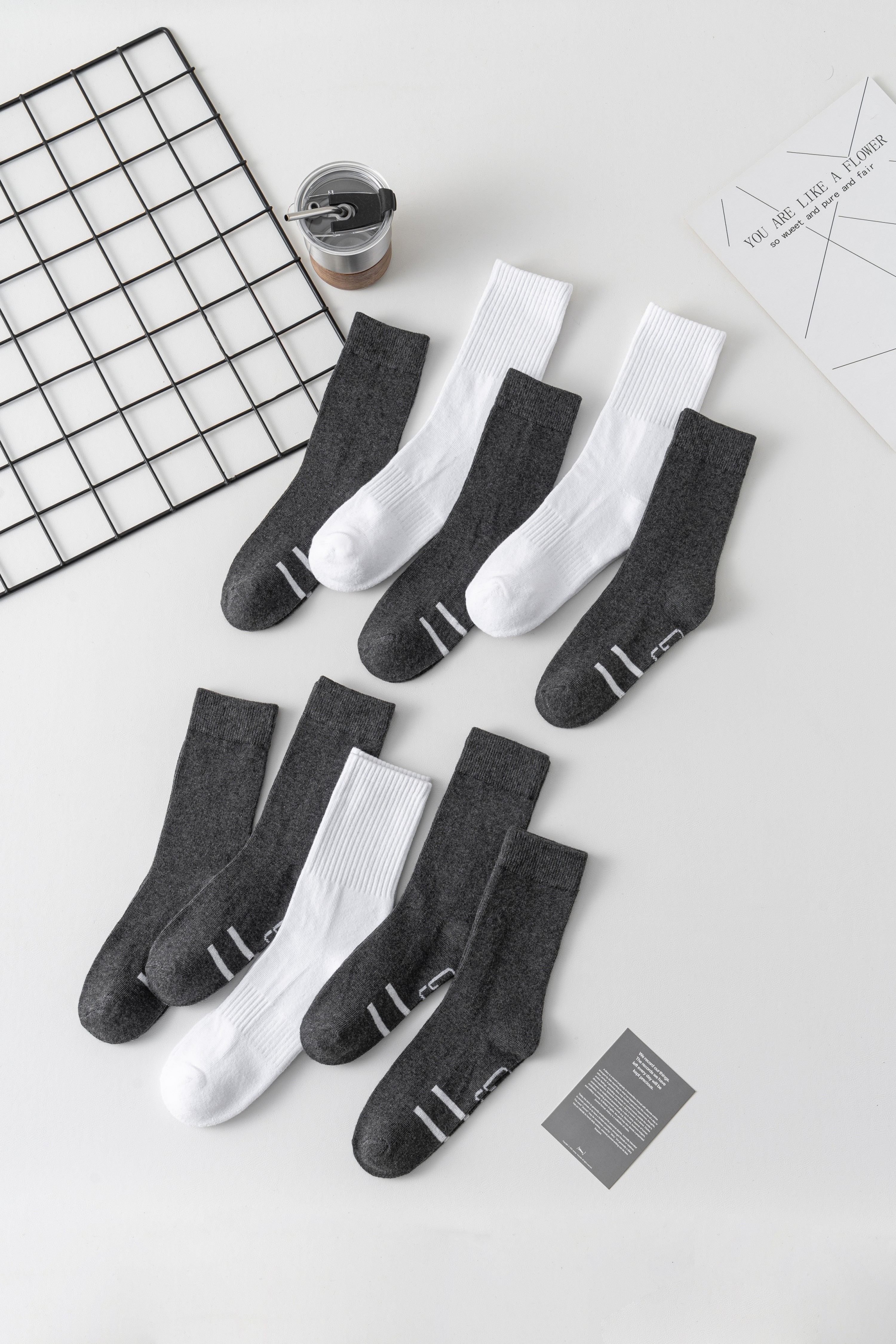 Charcoal and white school socks arranged in a flatlay
